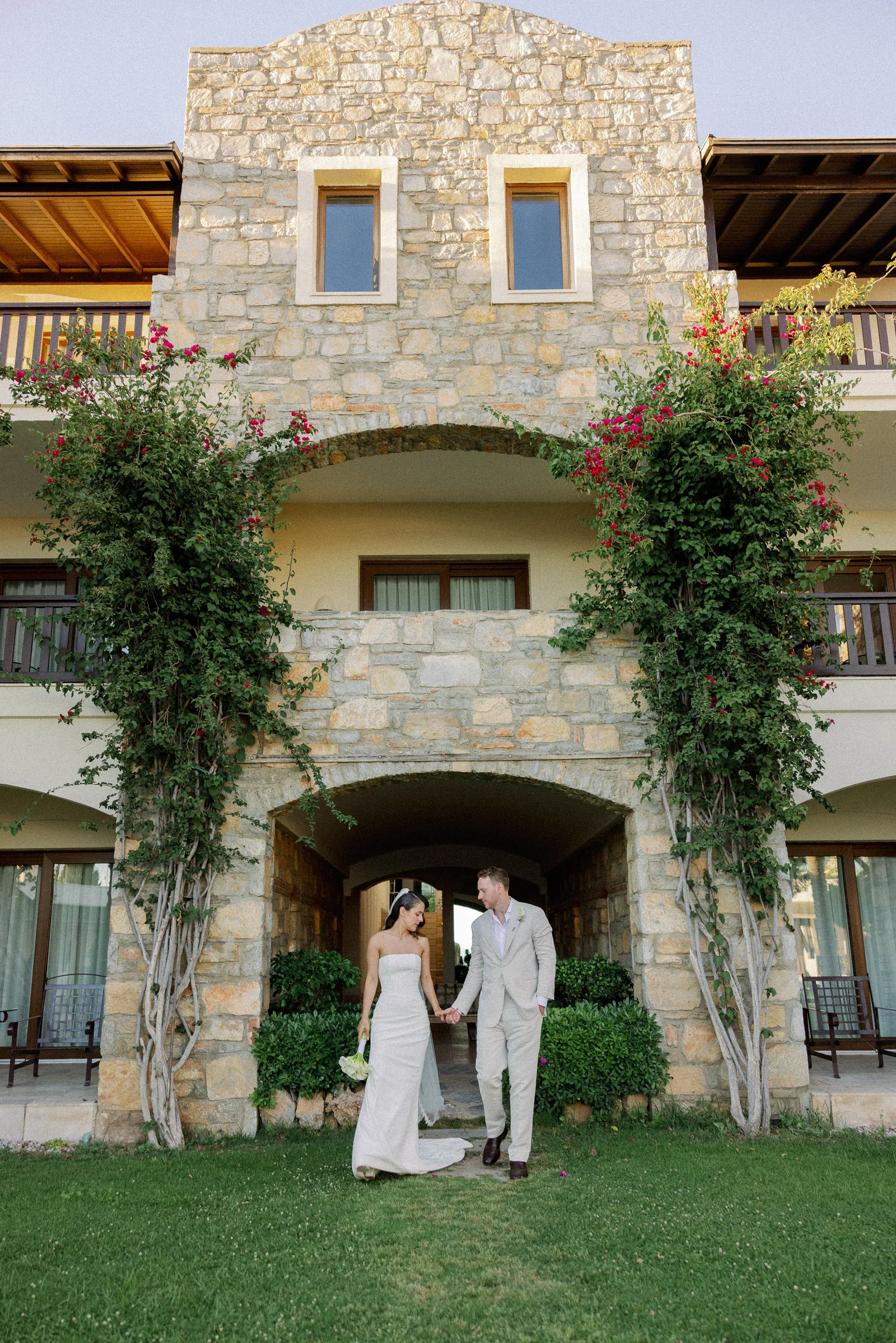 The couple in front of the stone building with bougainvillea, The Marmara Bodrum