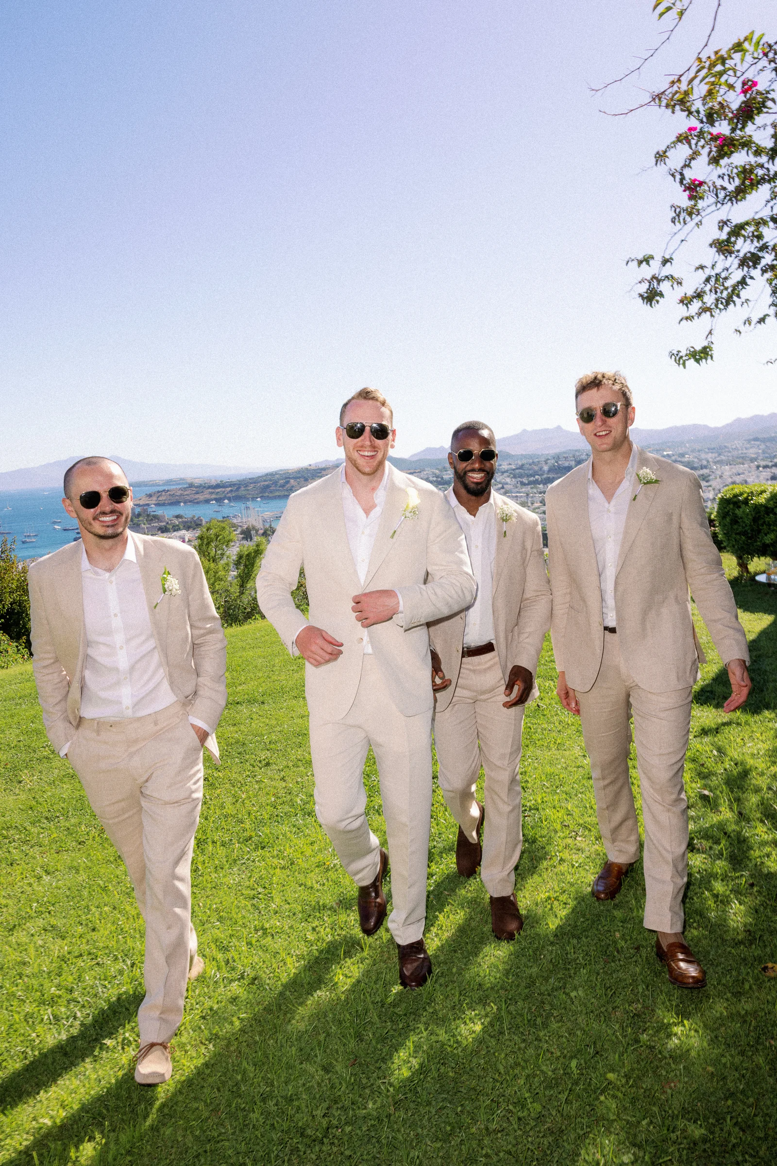 Groomsmen walking across the lawn, The Marmara Bodrum