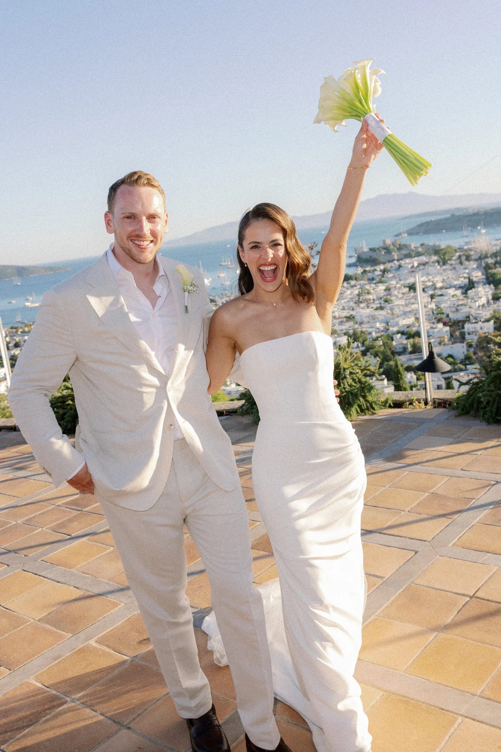 The couple on the terrace with the bouquet raised, The Marmara Bodrum
