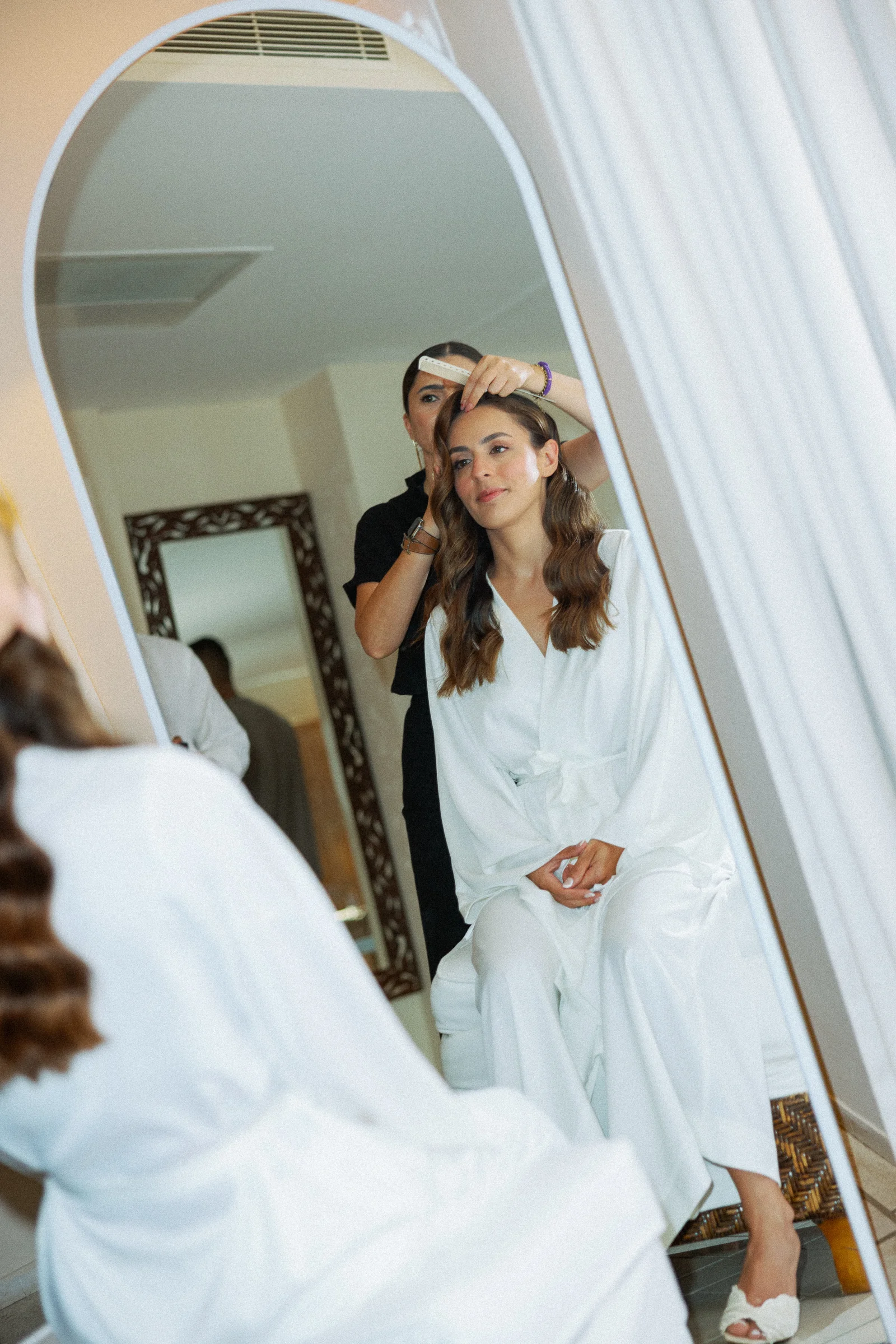 Bride having her hair done in the mirror, The Marmara Bodrum